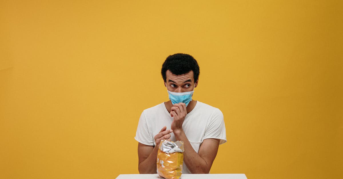 Is it safe to eat poisoned animals? - Man in White Crew Neck T-shirt Eating Chips