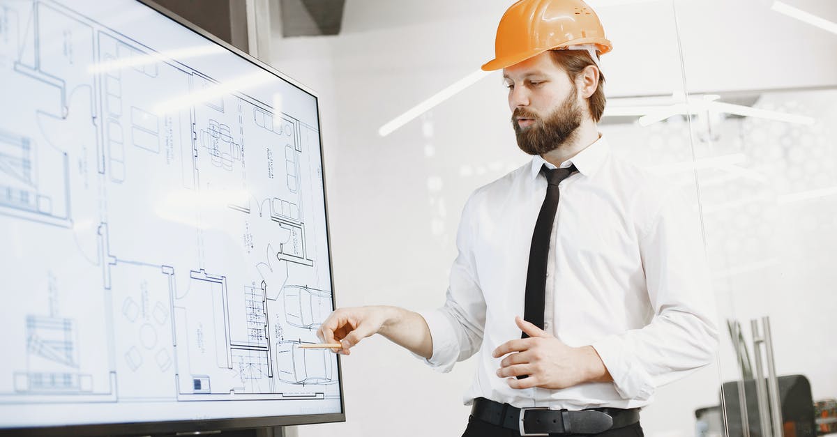 Is it yet possible to blueprint Concrete? - Man in White Dress Shirt and Orange Hard Hat Holding White Printer Paper