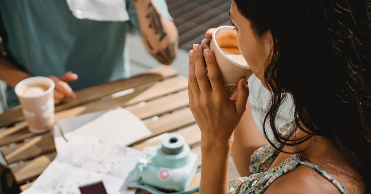 Is map refreshing instantly after destroying an altar? - From above of crop anonymous couple drinking coffee while sitting at table with map and instant photo camera during vacation together