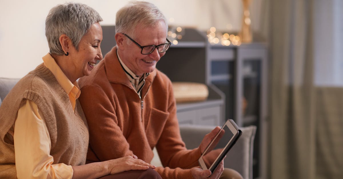 Is Sans older than Papyrus? - Couple Smiling While Looking at a Tablet Computer