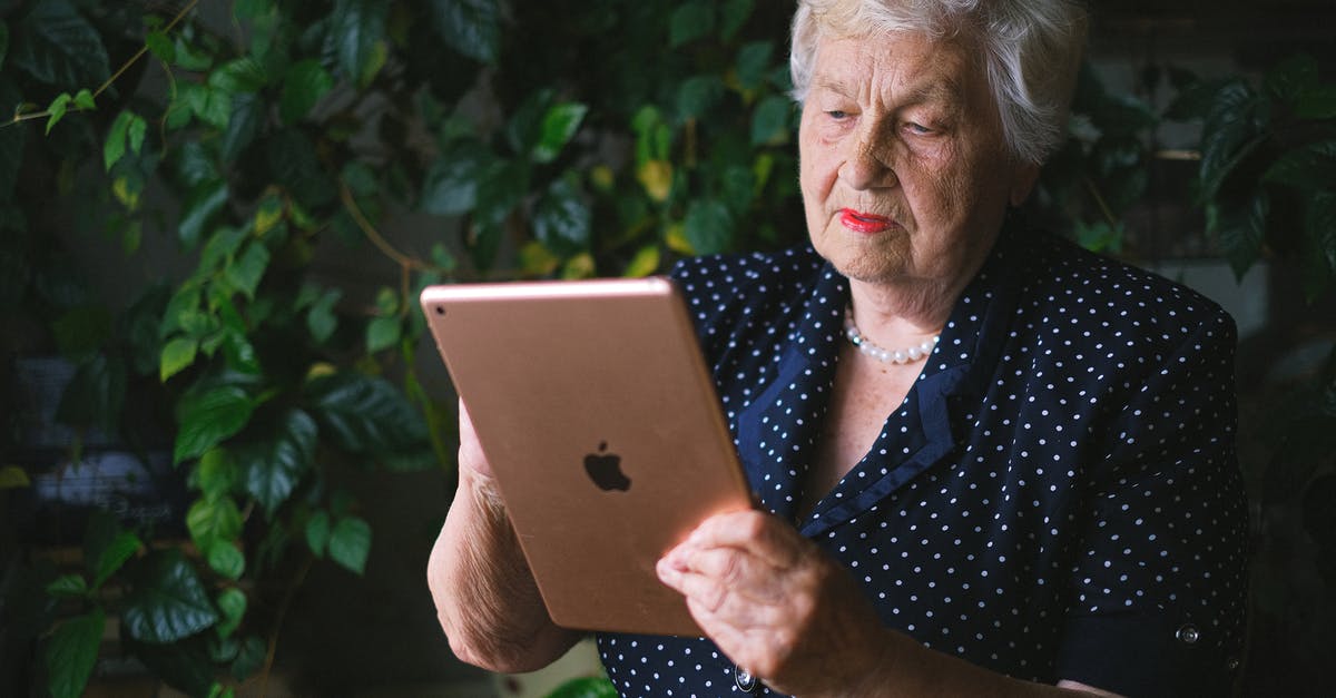 Is the clan emblem used anywhere except the clan page? - Senior woman touching screen of contemporary tablet