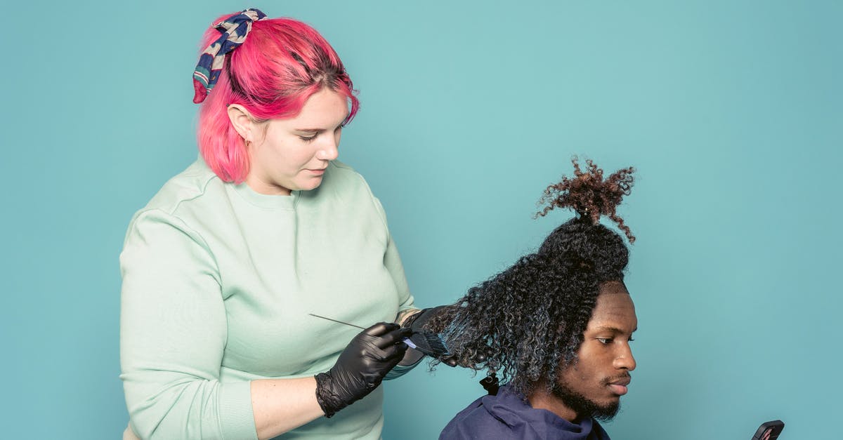 Is there a connection between The Master and MODUS? - Hairdresser applying paint on hair of black client