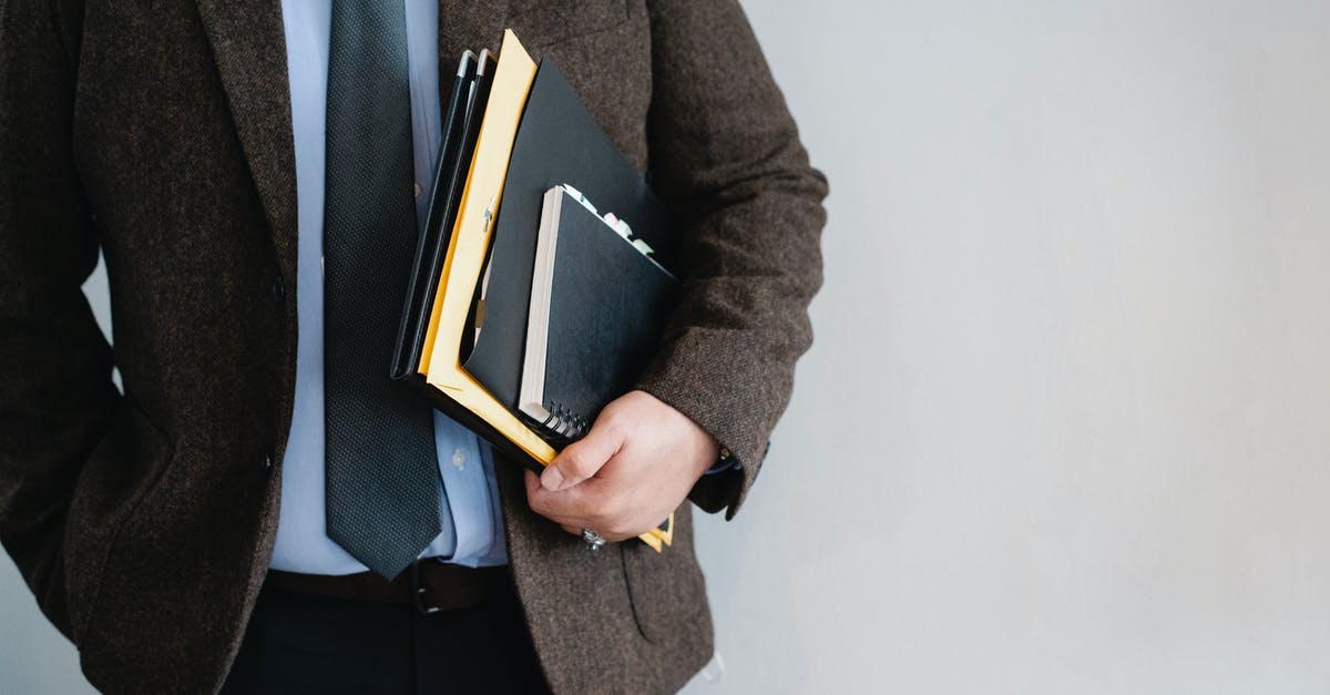 Is there a file limit? - Crop unrecognizable office worker standing with papers in hand