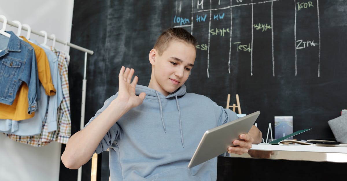 Is there a game called Sonic: The Next Level? - Photo of Boy Wearing Gray Hoodie While Using Tablet