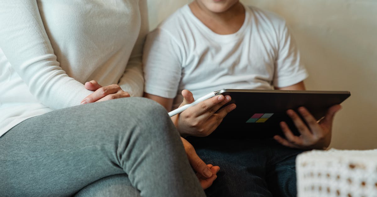 Is there a game called Sonic: The Next Level? - Unrecognizable woman with son using tablet at home