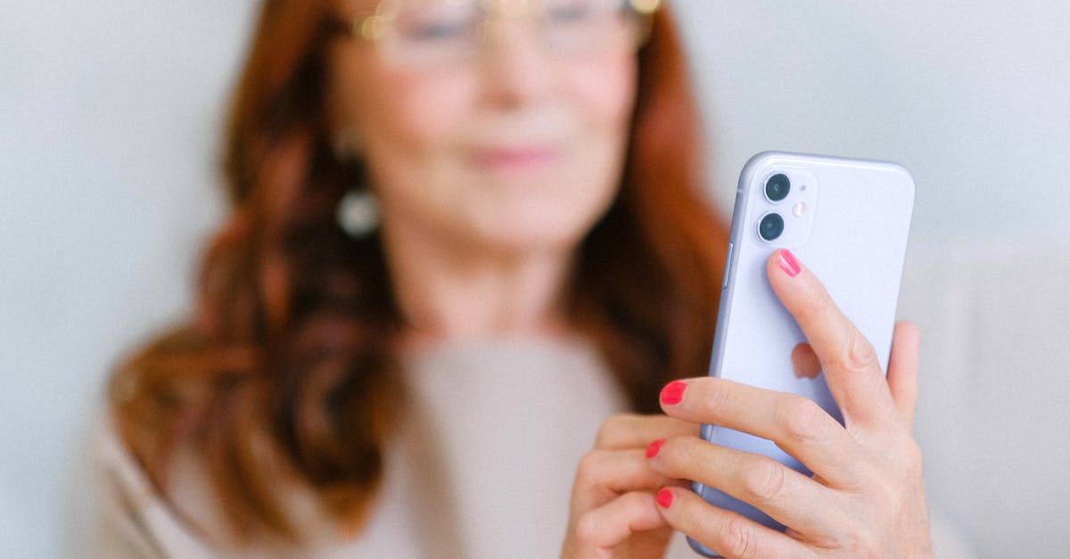 Is there a “special edition” version of The Elder Scrolls Online? - Crop aged redhead female in eyeglasses using contemporary mobile phone while surfing internet in soft focus