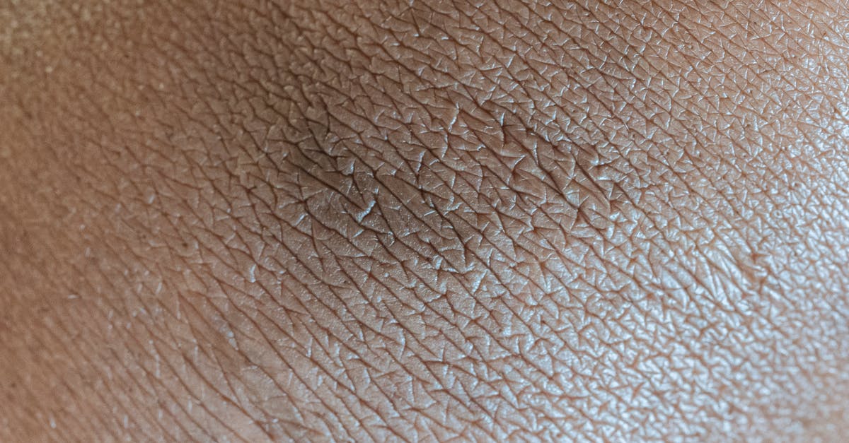 Is there a pattern of removed skin parts that is connected to wearoff percantage? - Textured background of skin surface with linear pattern and pigmentation spot in center Is there a pattern of removed skin parts that is connected to wearoff percantage? - Textured background of skin surface with linear pattern and pigmentation spot in center