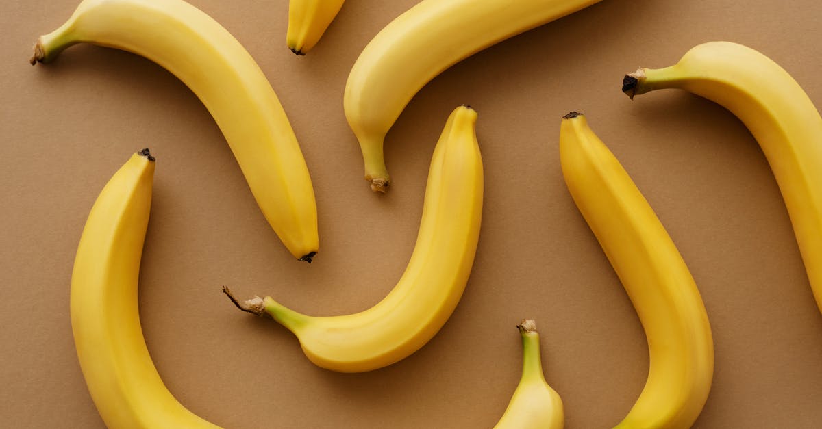 Is there a pattern of removed skin parts that is connected to wearoff percantage? - Yellow Banana Fruits on Brown Surface Is there a pattern of removed skin parts that is connected to wearoff percantage? - Yellow Banana Fruits on Brown Surface