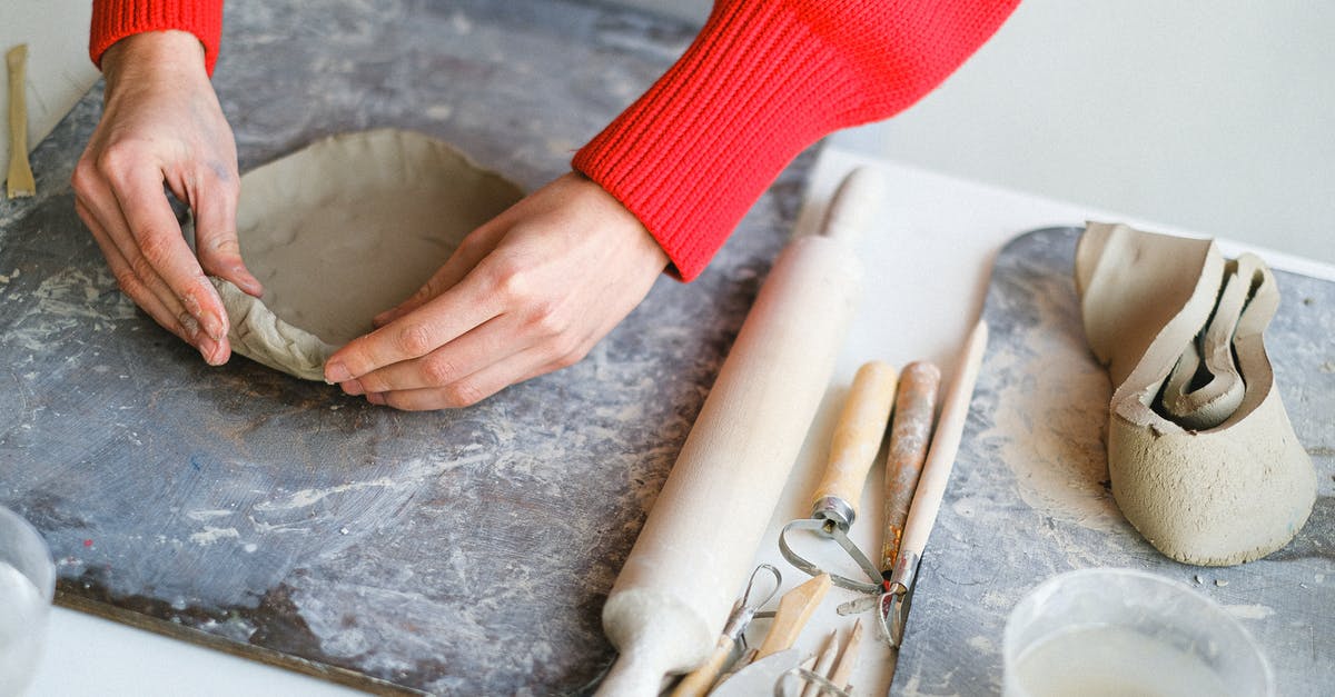 Is there a reason to keep duplicate mastered pins? - Crop woman molding clay on board