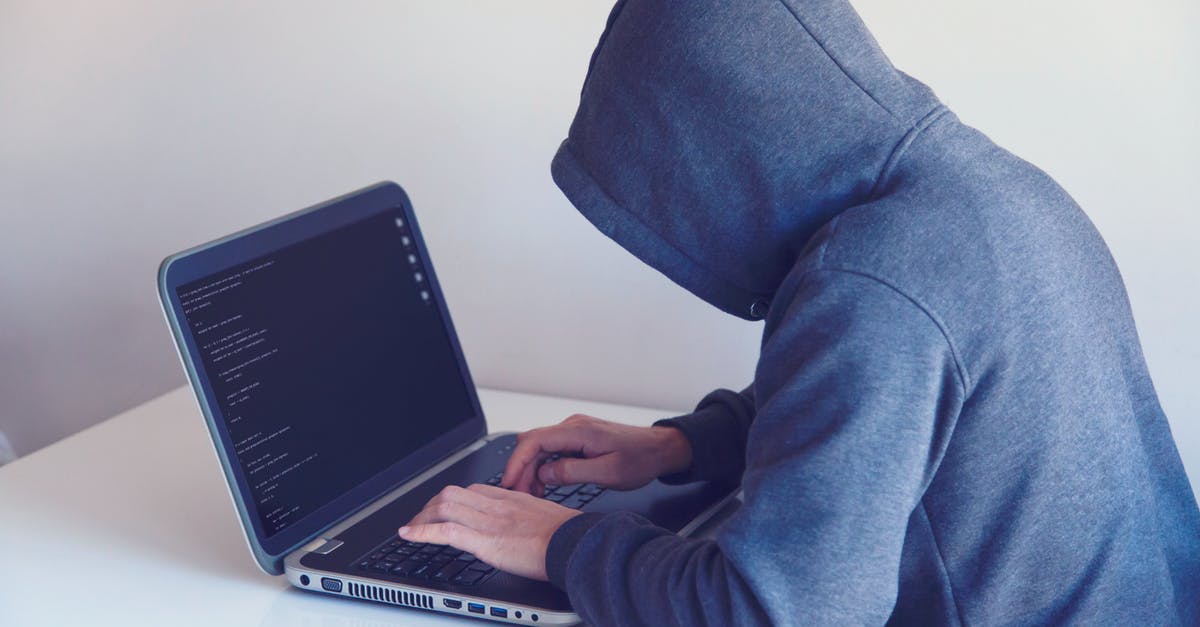 Is there a term for using cover to artificially block AI attacks? - Side view of unrecognizable hacker in hoodie sitting at white table and working remotely on netbook in light room near wall Is there a term for using cover to artificially block AI attacks? - Side view of unrecognizable hacker in hoodie sitting at white table and working remotely on netbook in light room near wall