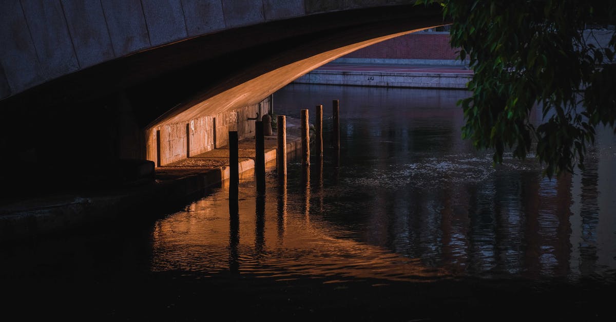 Is there a way to connect single engine to multiple outputs? - Narrow space and enclosure under concrete bridge over calm rippling river in dusk