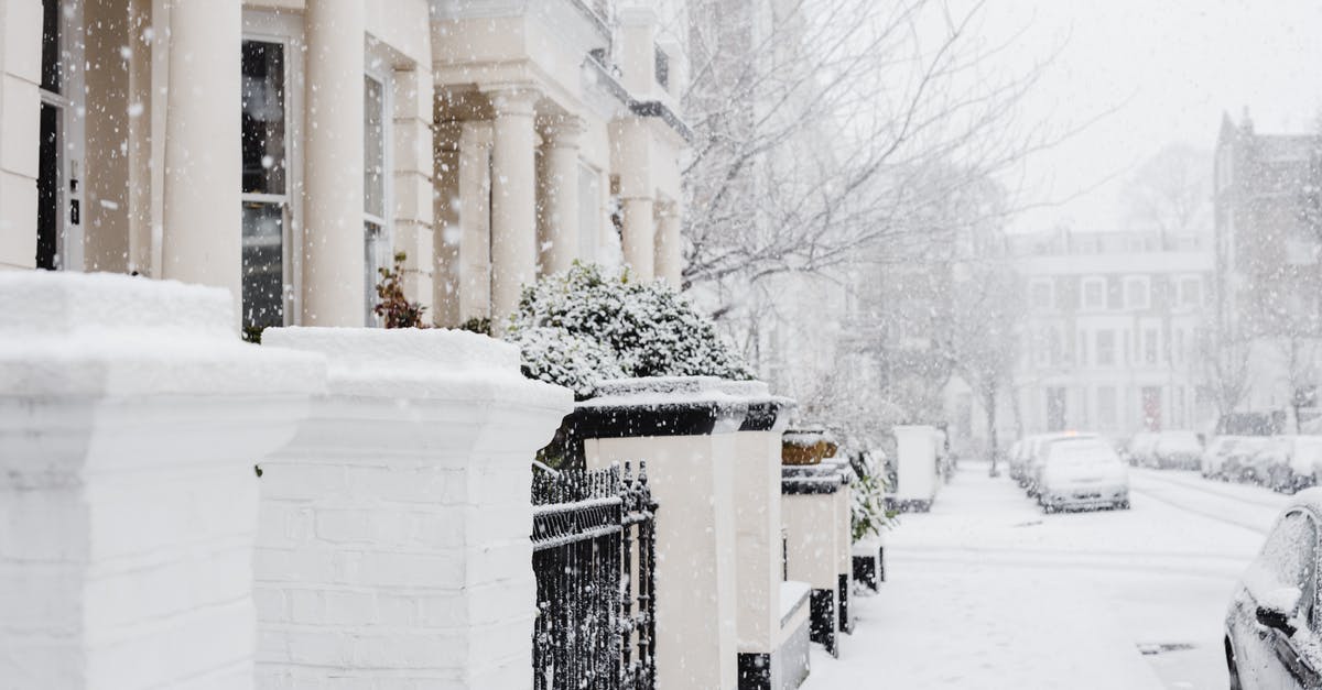 Is there a way to disable the snow version of maps? - Snowy street with residential buildings