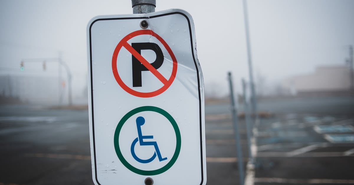 Is there a way to disable upgraded special agents? - White disabled parking sign on post located on empty asphalt parking lot with marking line on street in foggy weather