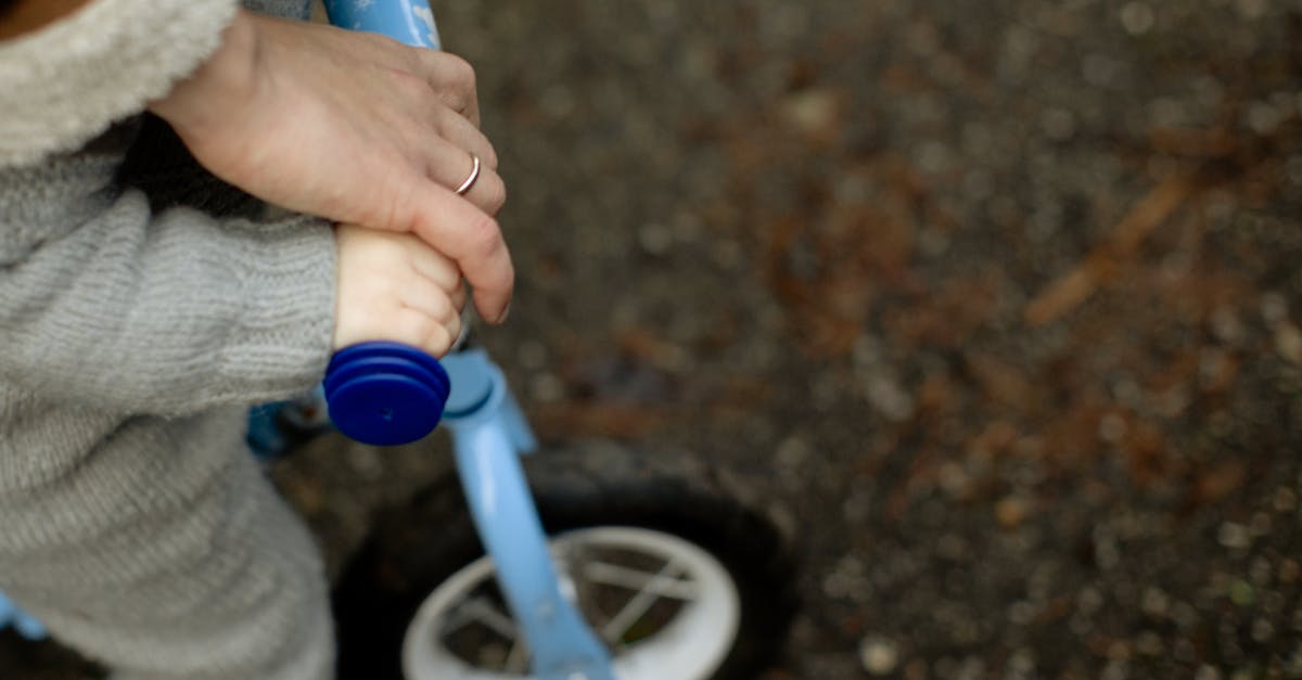 Is there a way to enumerate active buffs/debuffs on a character? - From above unrecognizable crop father teaching little kid how to ride bicycle on wet asphalt road during walk together in autumn day