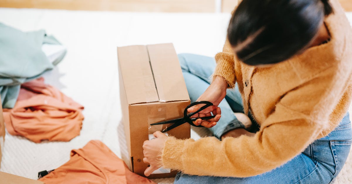 Is there a way to revert tool order customizations? - Woman cutting off adhesive tape from box with parcel