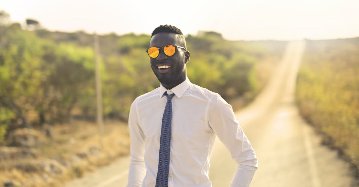 Is there a way to see ping in Fall Guys? - Happy man in formal wear and glasses in countryside