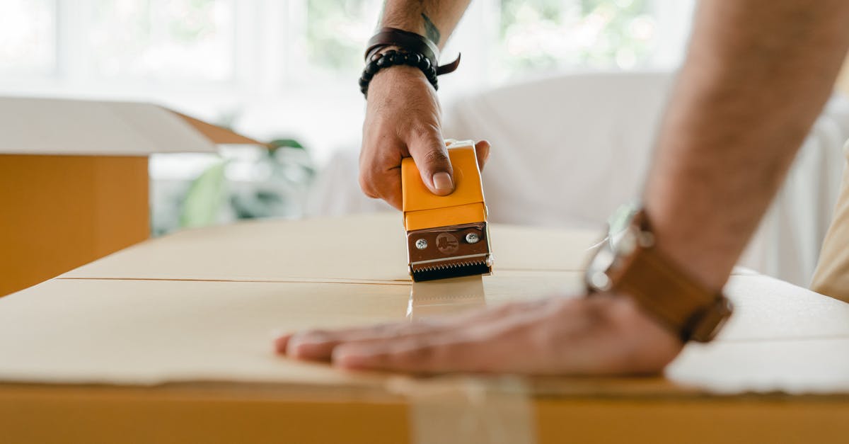 Is there a way to tell when the dispensers are going to dispense their item? - Crop man packing carton box with scotch tape dispenser Is there a way to tell when the dispensers are going to dispense their item? - Crop man packing carton box with scotch tape dispenser