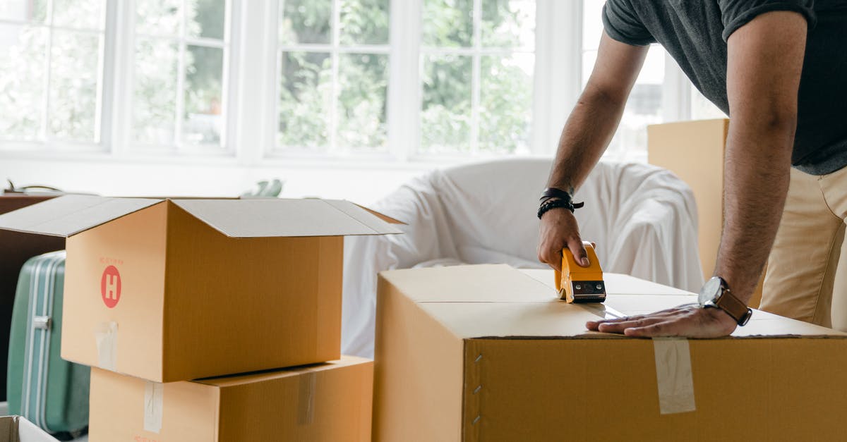 Is there a way to tell when the dispensers are going to dispense their item? - Crop unrecognizable man in casual clothes packing carton box using scotch tape dispenser for moving personal items to new apartment Is there a way to tell when the dispensers are going to dispense their item? - Crop unrecognizable man in casual clothes packing carton box using scotch tape dispenser for moving personal items to new apartment