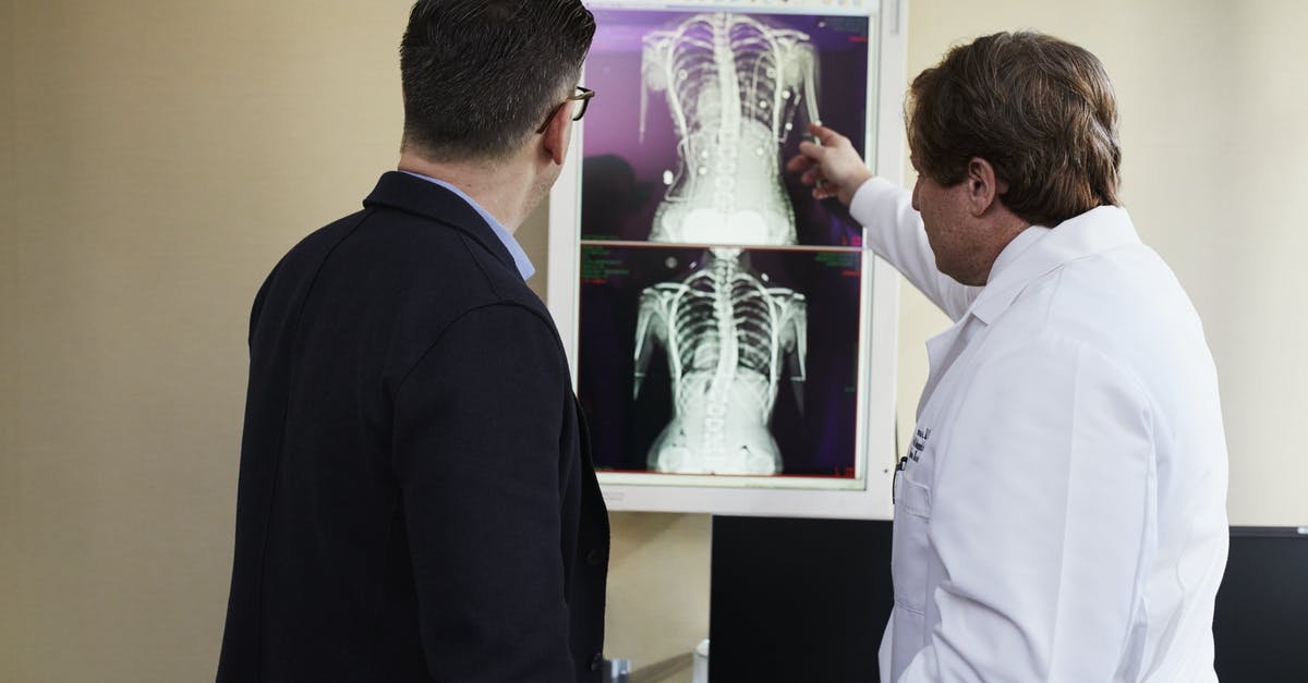 Is there an explanation of how ECHOs work, technologically? - Doctor Pointing X-ray Result Beside Man Wearing Black Suit