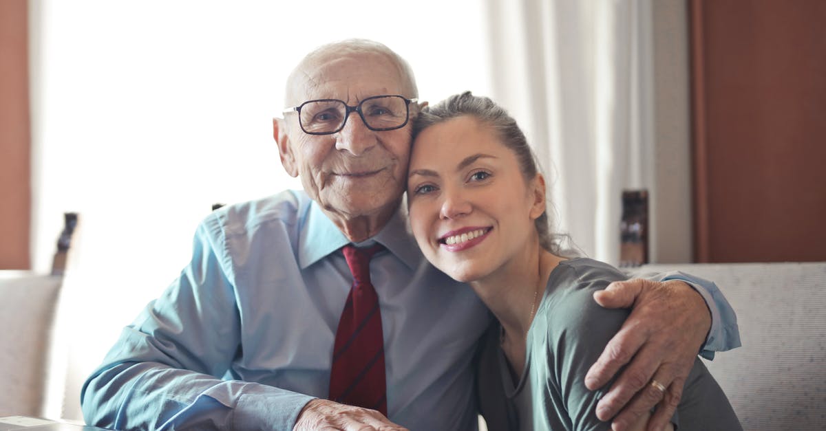 Is there any kind of official/recommended ruleset for tournaments? - Positive senior man in formal wear and eyeglasses hugging with young lady while sitting at table