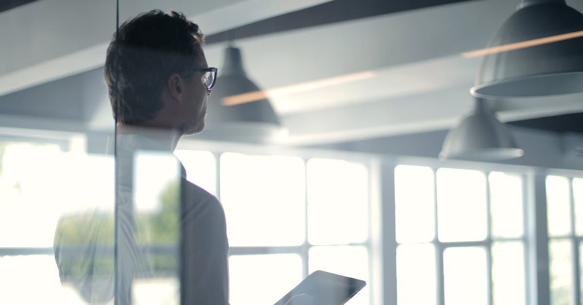 Is there any point in overpaying a merchant? - Formal man with tablet giving presentation in office