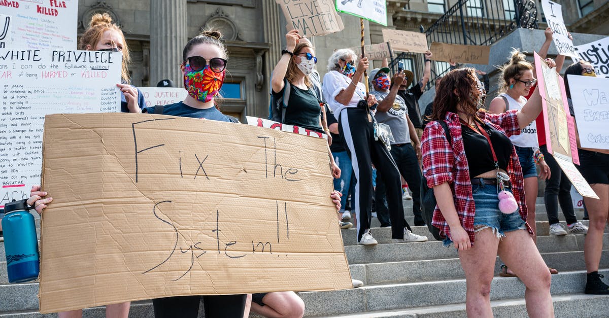 Is there any point to raise social stats to rank 5? - Unrecognizable protesters with BLM placards in demonstration on staircase