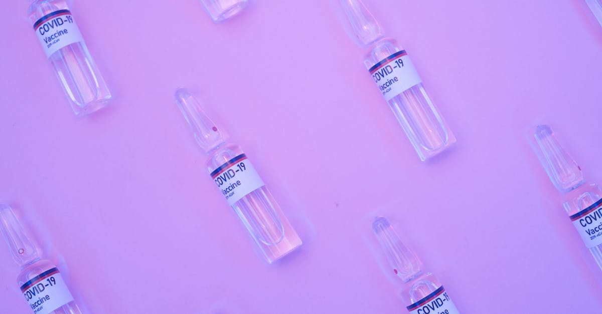 Is there any way to reduce repeated science experiments? - Background of similar ampoules with COVID 19 vaccine placed on table under neon purple light