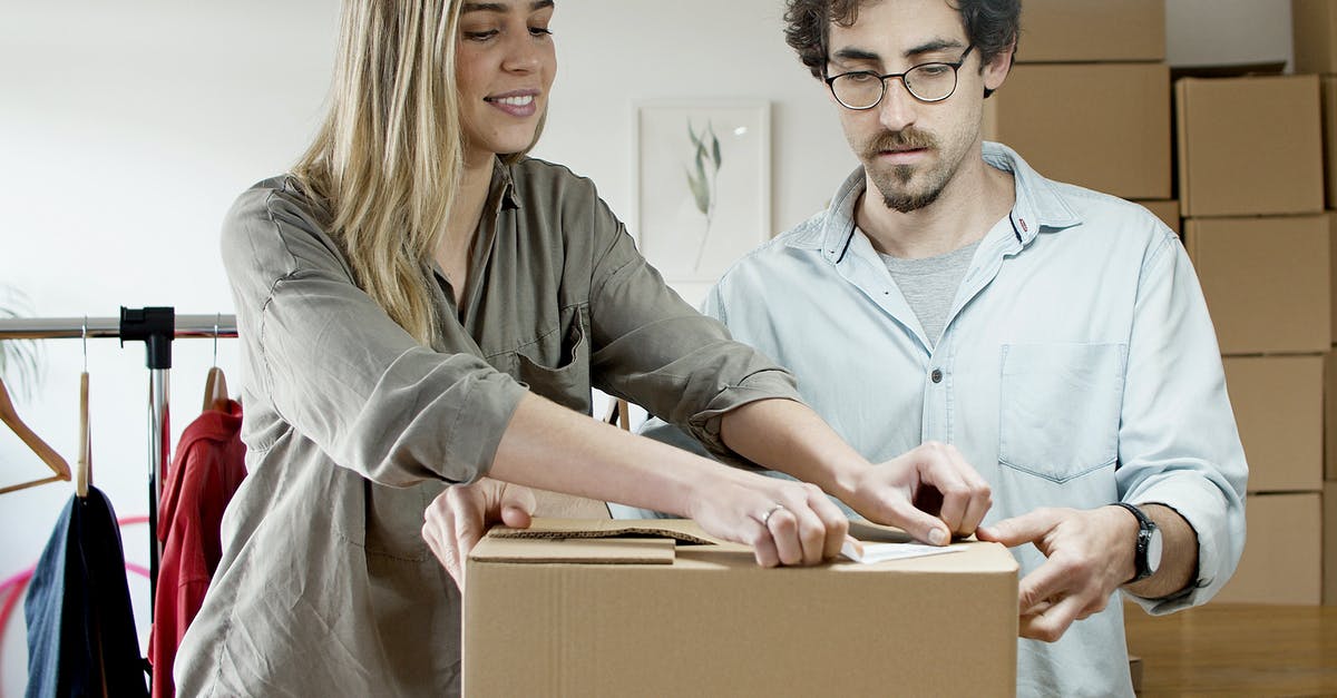 Light boxes troubles - Woman Putting the Sticker on the Box