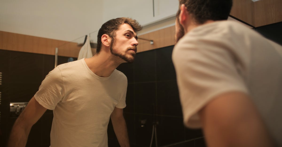 Lights on Xbox slim won't turn on and controller doesn't connect - Stylish concentrated man looking in mirror in bathroom