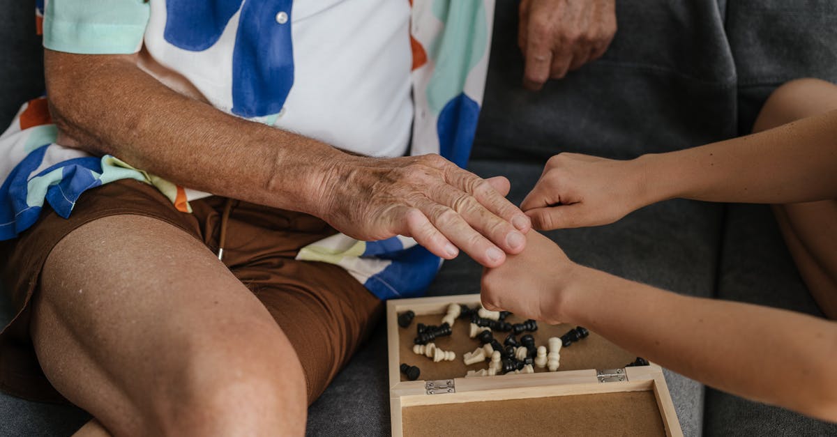 Listing the abilities of the game - Person in Blue Shirt and White Pants Holding Black and White Chess Piece