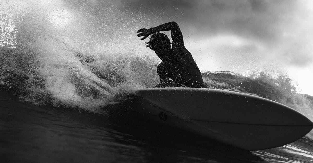 List/map of loot findable near crash sites? - Black and white of anonymous male surfer riding on wave with raised arm against cloudy sky in stormy weather outside