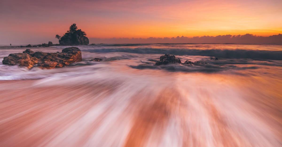 Long-distance fluid handling with pipes - Stormy sea with fast water flow on beach at sunset