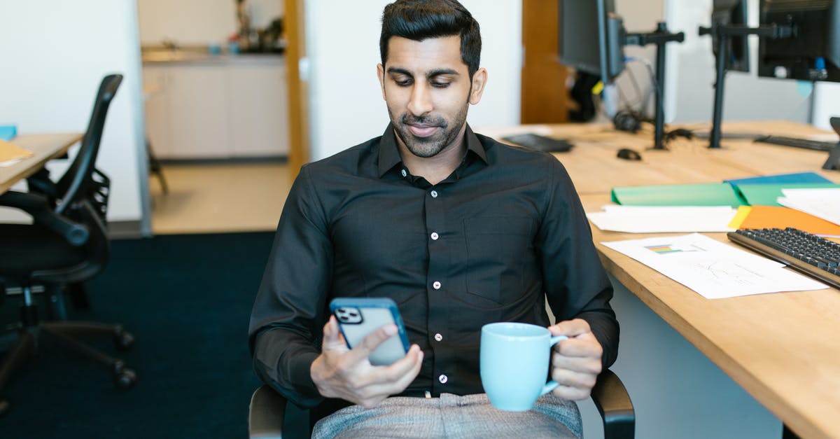 Looking for where addons are downloaded in files - Man in Black Dress Shirt Holding Blue Ceramic Mug