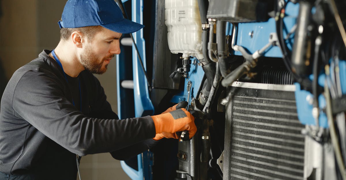 Melding commands with mastered abilities - Man in Black Long Sleeve Shirt Repairing Blue Machine