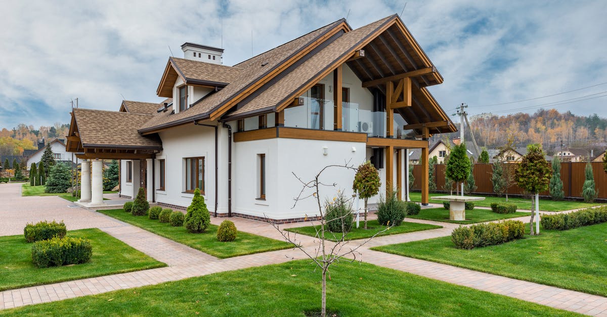 Mesecon lua microcontroller print location - Exterior of modern cottage house with columns and balcony surrounded by green grass and trees