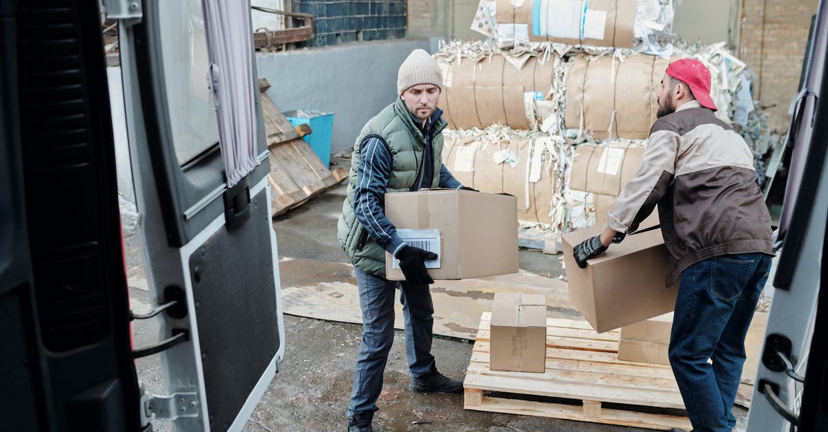 Minecraft Bedrock Chunks not loading - Man in Blue Denim Jacket and Blue Denim Jeans Standing Beside Cardboard Boxes