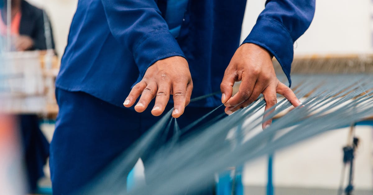 Minecraft Server crashing overnight (using too many threads?) [closed] - Crop unrecognizable craftsman in blue uniform unraveling thin threads on loom machine while working in studio with ethnic colleague