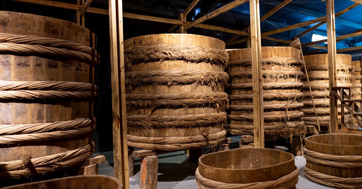 Miners ignore storage barn near the mine - Fish sauce fermenting in wooden large barrels placed in row in local manufacture factory