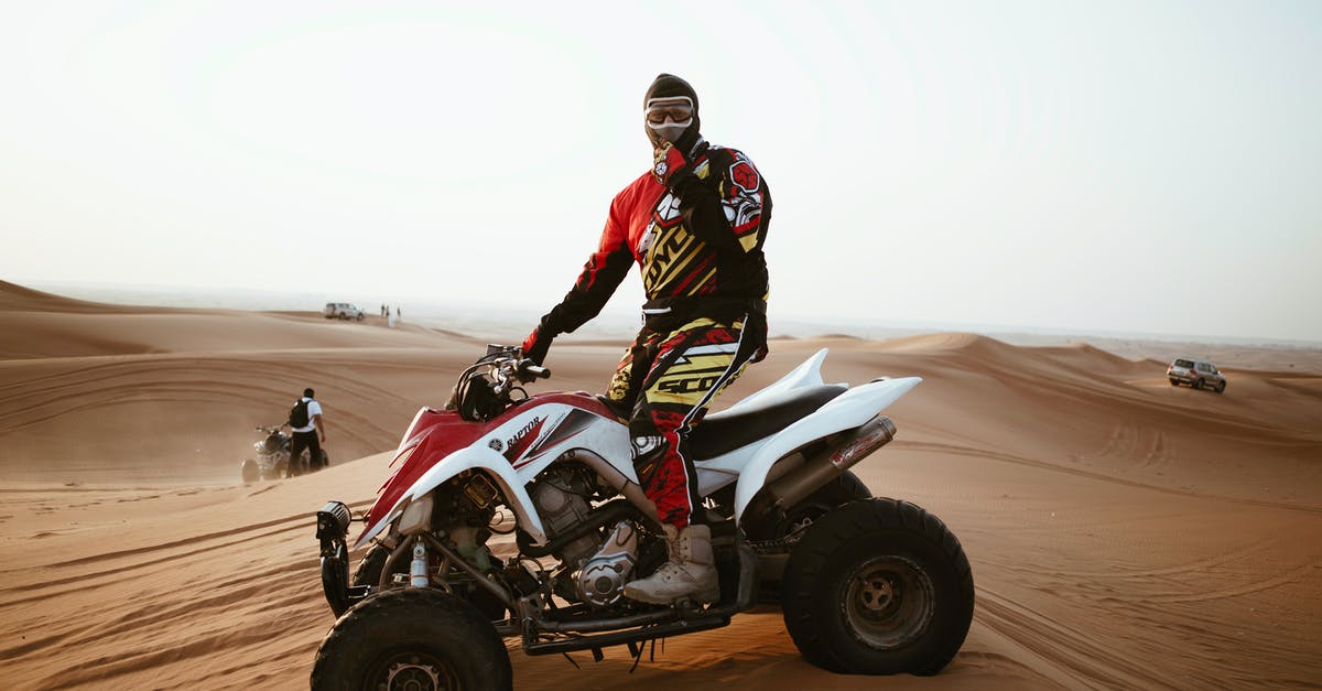 Motor skill: Let speed come naturally? - Man in helmet on quad bike in desert