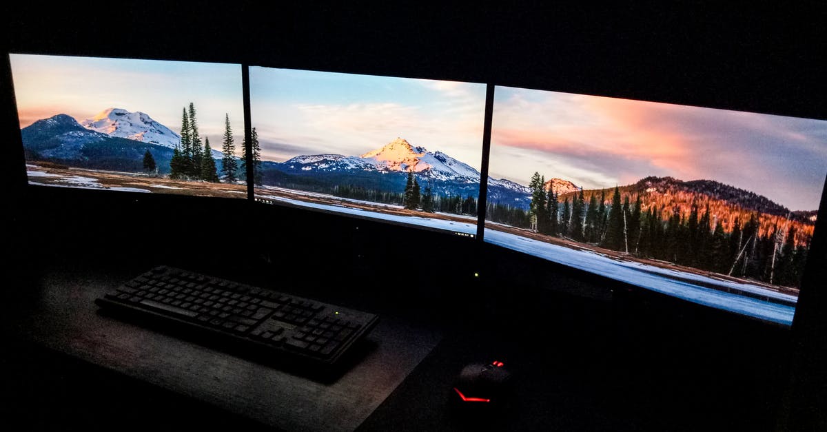 Mouse delay only when moving around in Minecraft Java Edition? - Contemporary computer with picturesque nature photos on monitors near keyboard and mouse in dark room