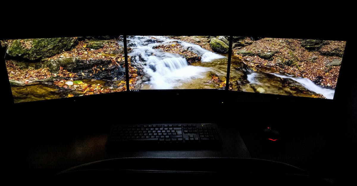 Mouse delay only when moving around in Minecraft Java Edition? - Modern computer with picturesque brook shown on screens placed on desk near keyboard and mouse in dark room