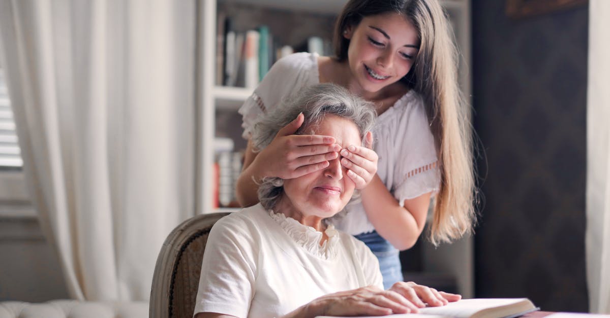 Multiple multiplayer games have the same connection issue - From below pensive gray haired woman trying to guess who closing eyes while sitting at table and reading book in light library in cottage