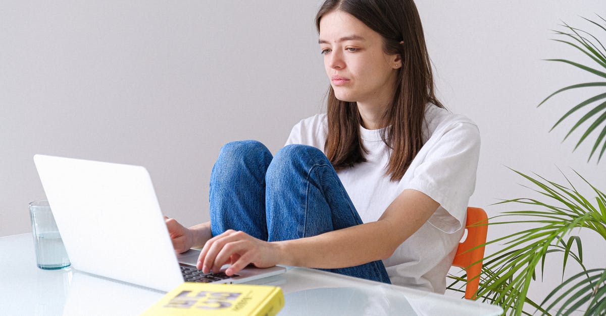 My End Portal isn't working - Woman in White Crew Neck T-shirt and Blue Denim Jeans Working on a Laptop