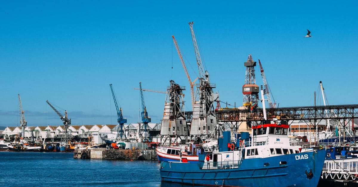 MyBoy! GBA stops/freezes when I load games? - Industrial dock with contemporary cranes and moored cargo vessels in blue water in sunlight