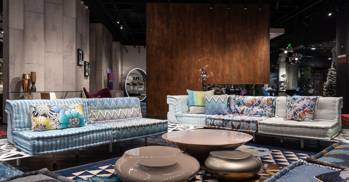 New ID signature for Ebon Hawk: does my choice matter? - Comfortable sofas with colorful cushions and creative coffee tables placed on carpet in modern spacious furniture store