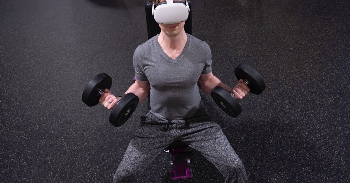 Oculus Quest 2 Cameras not working - A Man Lifting Dumbbells while Wearing Virtual Reality Goggles