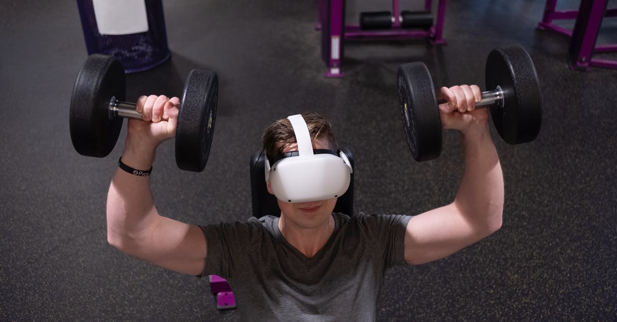 Oculus Quest 2 Cameras not working - A Man Lifting Dumbbells while Wearing Virtual Reality Goggles