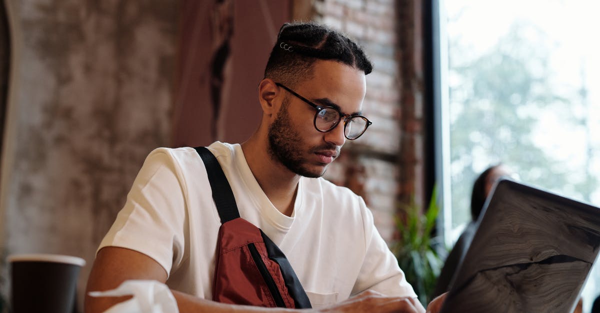 Online features ceased to work - Focused Man in Black Eyeglasses using a Laptop