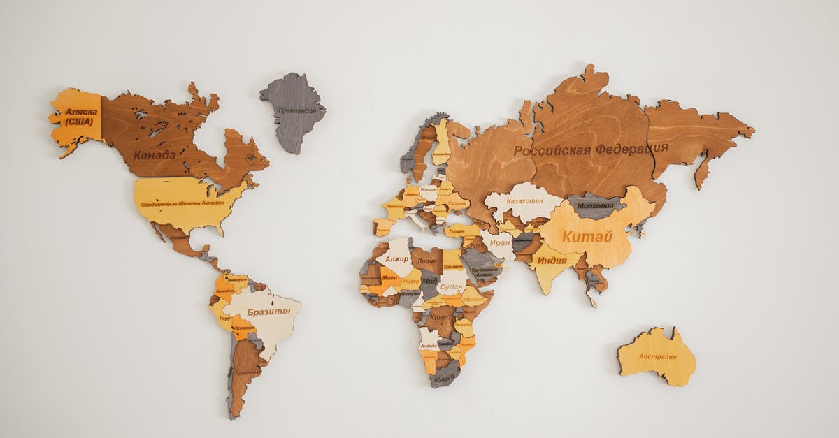 Origin of the name Brahmin in fallout - Decorative creative wooden world continents with country names written in Cyrillic attached on white background in light room of studio