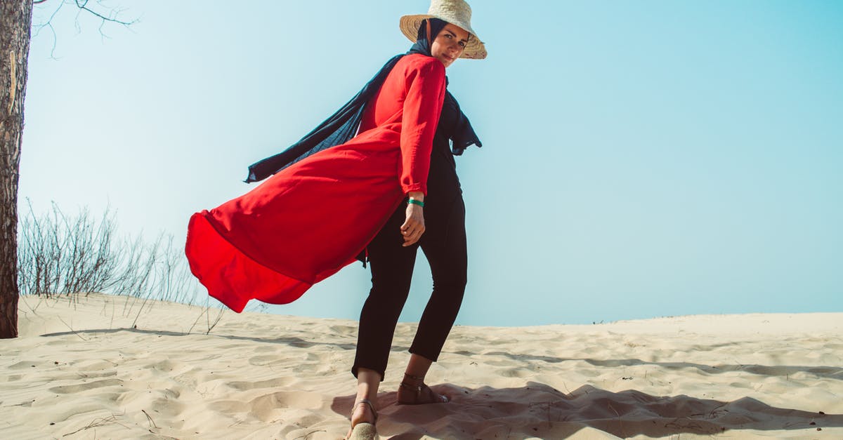 Outfit swap during exploration - Photo Of Woman Walking On Sand